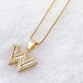 Luxury gold letter W pendant necklace with cubic zirconia on a plush background - Gold W
