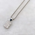 Silver rectangle necklace with micro-set zircon letter B pendant on plush background - Silver E