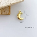 Macro shot of gold crescent moon pendant with star relief detailing and 15mm dimensions - Moon Design
