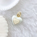 Detail of a white enamel heart pendant with gold plating on a soft plush background - Single Pendant (Chain Not Included) / Heart #3