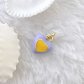 Close-up of heart charm with violet enamel, yellow center and golden metal ring - Heart #6