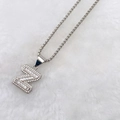 Silver-colored letter Z pendant necklace with zircon flower setting on white fur - Silver Z