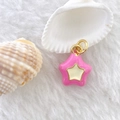 Macro shot of a pink 3D star pendant with gold ring on soft white fur background - Star #8