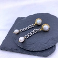 Elegant gold-trimmed double pearl drop earrings with silver chain tassel on grey stone base - Mixed Gold and Silver Pearl Tassel Style