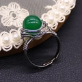 Macro shot of green bead handmade wire-wrapped stainless steel ring with adjustable band - Malay Jade