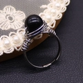 Handcrafted silver wire-wrapped ring featuring a round black stone and adjustable open band - Black Agate
