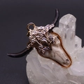 Macro shot of gold-plated bull skull pendant with floral embossing and bone texture - Black Horns Gold Pattern Style (6059255559588)