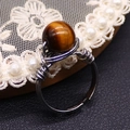 Handcrafted silver wire-wrapped ring featuring a natural tiger eye bead with an adjustable band - Tiger's Eye