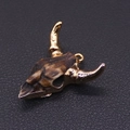 Macro detail of acrylic bull head pendant with golden horns and vintage bone texture - No. 1 (Brownish Antique Texture)