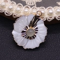 Detail view of flower shell pendant with grey crystal center and gold plated metal - White Crystal