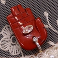 Macro shot of red agate Hamsa hand pendant with a marquise zircon and gold bail - 17x32mm / Red Jasper