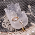 Detailed close-up of golden open ring with marquise and round cut gems on hand display - 17x32mm / White Crystal