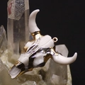 Detailed macro view of gold-plated acrylic bull skull pendant on crystal cluster - 46x50mm / Glossy White & Gold (No. 3)
