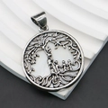 Detailed close-up of antique silver tree of life pendant with copper shell bezel - 32x36mm / Antique Silver Color