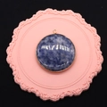 Detailed top view of a round blue natural stone pendant with a gold plated rim - Blue Spot Stone