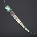 Detail macro view of natural abalone shell rectangular beads with iridescent pearly luster - Rectangle 6x8mm