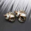 Close-up of DIY natural seashell pendants with golden electroplated edges for jewelry - Style 34