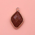 Macro detail of diamond-shaped goldstone pendant with elegant rose gold plating - 15x26mm / Gold Sandstone