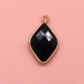 Detailed close-up of faceted black stone pendant with elegant gold plated metal frame - 15x26mm / Black Agate