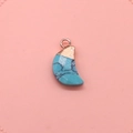 Macro detail of crescent moon blue turquoise pendant with elegant rose gold metal loop - Blue Turquoise