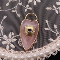 Pink gemstone heart pendant with golden evil eye design and sunburst engraving - Rose Quartz
