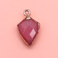 Detail of pink faceted shield stone pendant with gold plated metal edges and bail - Pink Chalcedony / 12x19mm