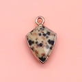 Macro detail of faceted shield-shaped Dalmatian Jasper pendant with rose gold plating - Dalmatian Jasper / 12x19mm