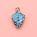 Macro detail of faceted blue turquoise shield pendant with gold plated metal frame - Blue Turquoise / 12x19mm