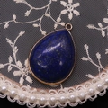 Detailed view of teardrop lapis lazuli pendant with gold plating and blue stone texture - Lapis Lazuli