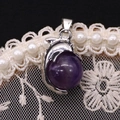 Macro shot of dolphin pendant with purple gemstone center on lace background - 14x23mm / Purple Crystal