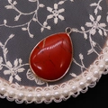 Teardrop red jasper gemstone pendant with gold metal rim and top bail accessory - Red Jasper