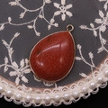 Teardrop red goldstone pendant with elegant gold plating and smooth polished finish - Gold Sandstone