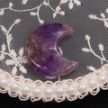 Macro shot of polished moon-shaped amethyst stone with natural purple textures on lace - 25x30mm, 8mm Thickness / Purple Crystal