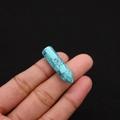 Macro shot of a turquoise hexagonal prism stone bead with natural black veins for DIY jewelry - 8x33mm / Blue Turquoise