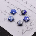 Detailed macro of five faceted star-shaped Lapis Lazuli pendants for DIY jewelry making - Lapis Lazuli