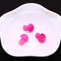 Detailed view of pink mushroom dragon vein agate stones in a white floral ceramic bowl - Pink