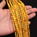 Dettaglio macro di perle in diaspro imperiale giallo a forma di osso con trama incrinata - 4x6MM / Giallo Arancio