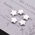 Macro shot of star-shaped white turquoise stone beads with gray marble textures for DIY jewelry - Howlite