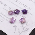 Macro shot of faceted star-shaped amethyst beads for DIY jewelry making and necklaces - Purple Crystal