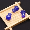 Macro detail of three blue mushroom stone carvings with natural polished textures - Lapis Lazuli (No. 4)