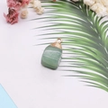 Detailed macro view of natural green crystal stone pendant with golden electroplated edge - Green (No. 6)