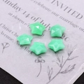 Detail view of five faceted star-shaped light green natural stone pendants for DIY jewelry - Number 2 (Light Green Aventurine Style)