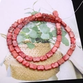 Macro detail of red bow-shaped stone beads for DIY jewelry making and crafting projects - Red