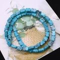Macro view of bright blue butterfly-shaped turquoise beads with natural mineral texture - Bright Blue