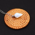 Hexagonal white opal crystal perfume bottle pendant necklace with silver chain on black mat - Opal