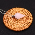Pink quartz hexagonal perfume bottle necklace with silver chain on a woven mat - Rose Quartz