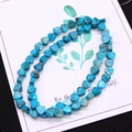 Macro shot of turquoise heart-shaped beads with natural brown mineral veins for jewelry - 1 Piece / Cyan Blue