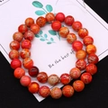 Makroaufnahme orangefarbener Imperial-Steinperlen mit Netzstruktur für DIY-Schmuck - Größe 16