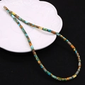 Close-up of 4x8mm colorful natural stone cylinder beads scattered on a textured dish - 4x8mm / Bright Mixed (No.16)