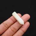 Close-up of a white crystal hexagonal point held by hand to show the size for DIY jewelry - 8x33mm / Ivory Jade
